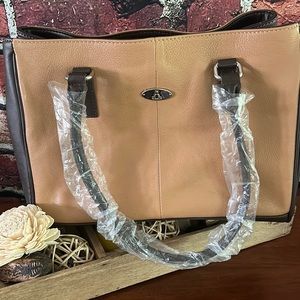 Genuine Leather with man-made trim handbag.